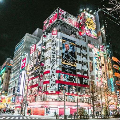 Des jeunes couples asiatiques échangeant des cadeaux dans un centre commercial décoré pour Noël, symbolisant l'influence croissante de la mondialisation sur les traditions locales.