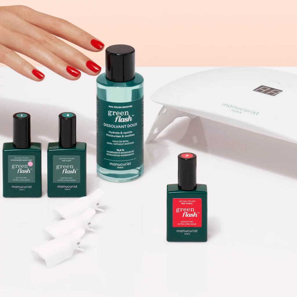 Un coffret Manucurist élégant posé sur une table en bois clair, contenant plusieurs flacons de vernis Green aux teintes douces et naturelles, accompagné d’un petit livret explicatif et d’une lime à ongles. L’ensemble est soigneusement rangé dans une jolie boîte, parfaite pour offrir en cadeau d’anniversaire à sa maman. L’image évoque un moment de soin personnel, de douceur et de raffinement, avec une touche green et éthique qui séduira une mère soucieuse de sa santé comme de la planète.