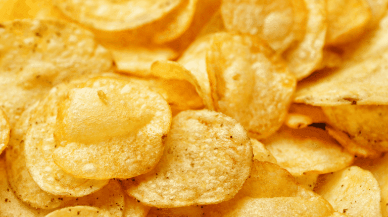 Air fryer posé sur un plan de travail de cuisine avec panier ouvert contenant des légumes rôtis et une petite grille surélevée, illustration des astuces avancées pour optimiser la cuisson et la texture des aliments