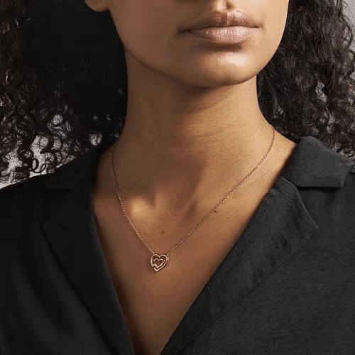 Colliers Cléor avec pendentif cœur en argent, modèles multi-rangs en acier doré et colliers prénom personnalisés posés sur un fond doux et clair.