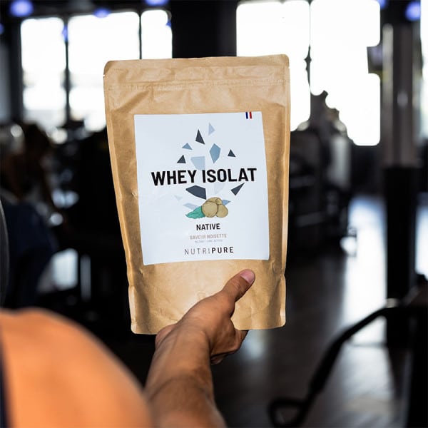 Whey isolate en cours de mélange dans un shaker avec de l’eau montrant une texture fluide sans grumeaux